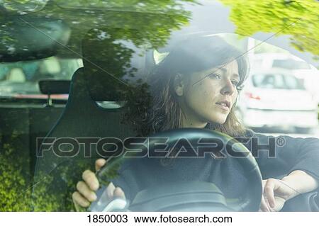 Stock Image - Woman driving car. Fotosearch