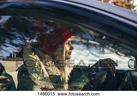 Woman in warm clothing driving car View Large Photo Image Stock Photography - Woman in warm clothing driving car. Fotosearch