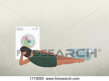 Woman laying and watching clothes drying in dryer View Large Photo Image Stock Image - Woman laying and watching clothes drying in dryer. Fotosearch