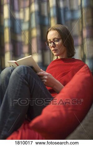 Stock Photo - Woman reading book, relaxing. Fotosearch
