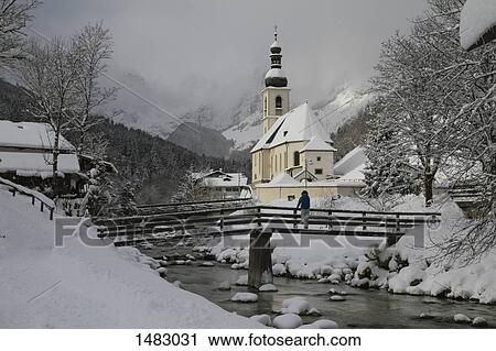 Woman standing on bridge over river amidst snow covered field View Large Photo Image Stock Image - Woman standing on bridge over river amidst snow covered field. Fotosearch