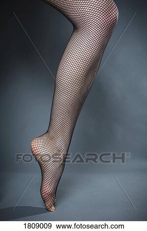 Womans leg in fishnet stocking View Large Photo Image Stock Photo - Womans leg in fishnet stocking. Fotosearch