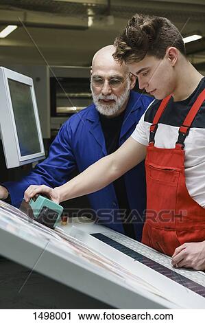 Workers checking quality of print with scanner at printing press View Large Photo Image Stock Image - Workers checking quality of print with scanner at printing press. Fotosearch