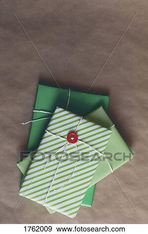 Wrapped Christmas presents in a stack View Large Photo Image Stock Photo - Wrapped Christmas presents in a stack. Fotosearch