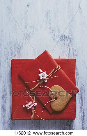 Stock Image - Wrapped Christmas presents on wooden background. Fotosearch