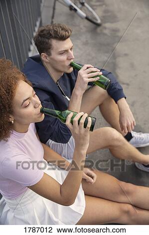 Young couple drinking beer View Large Photo Image Stock Image - Young couple drinking beer. Fotosearch