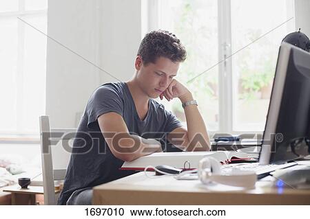 Young handsome university student studying at home View Large Photo Image Stock Image - Young handsome university student studying at home. Fotosearch