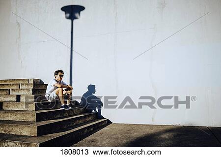 Young male runner resting on sunny urban steps View Large Photo Image Stock Image - Young male runner resting on sunny urban steps. Fotosearch