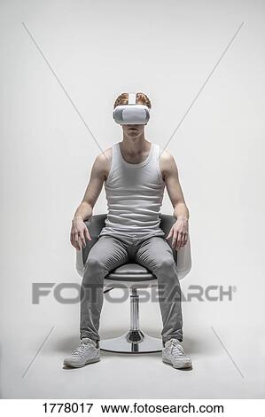 Young man using virtual reality simulator glasses View Large Photo Image Stock Photo - Young man using virtual reality simulator glasses. Fotosearch