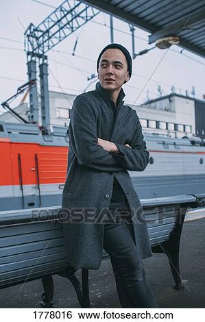 Young man waiting on railroad station platform View Large Photo Image Stock Photograph - Young man waiting on railroad station platform. Fotosearch