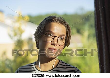 Young woman listening to music with headphones View Large Photo Image Stock Photography - Young woman listening to music with headphones. Fotosearch