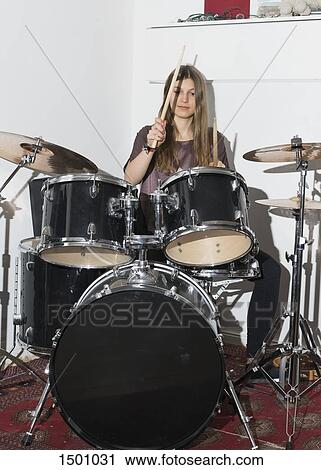 Young woman playing drums View Large Photo Image Stock Image - Young woman playing drums. Fotosearch
