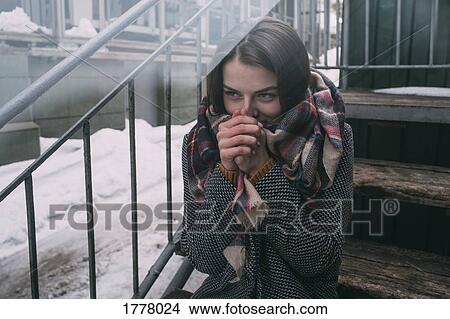 Young woman warming hands on cold, winter stoop View Large Photo Image Picture - Young woman warming hands on cold, winter stoop. Fotosearch