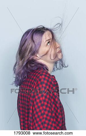 Young woman with dyed and tousled hair against blue background View Large Photo Image Stock Photo - Young woman with dyed and tousled hair against blue background. Fotosearch
