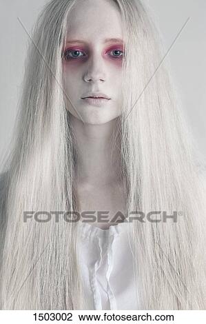 Young woman with spooky red eyes and long hair against white background View Large Photo Image Stock Image - Young woman with spooky red eyes and long hair against white background. Fotosearch