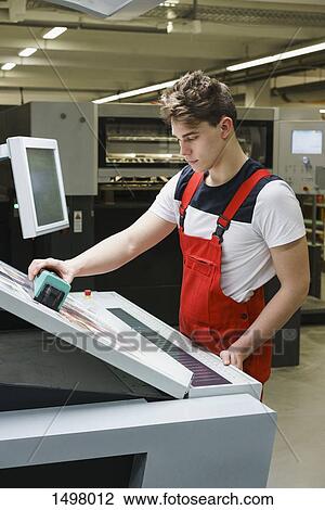 Young worker checking quality of printout with scanner at printing press View Large Photo Image Stock Image - Young worker checking quality of printout with scanner at printing press. Fotosearch