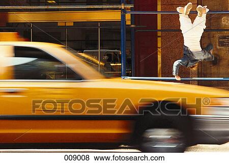 boy doing gymnastics, taxi drives by View Large Photo Image Stock Photo - boy doing gymnastics, taxi drives by. Fotosearch