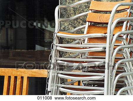 Stock Photo - chairs stacked next to a cafe. Fotosearch
