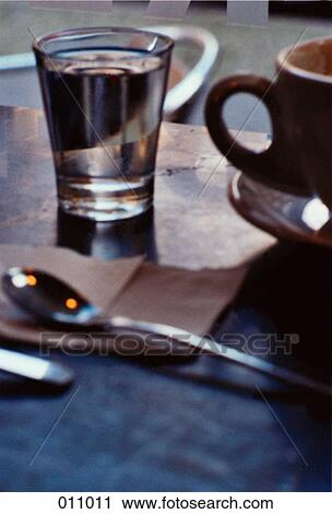 coffee cup, spoon and glass of water on a table View Large Photo Image Stock Image - coffee cup, spoon and glass of water on a table. Fotosearch