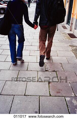 Stock Photo - couple walking holding hands. Fotosearch