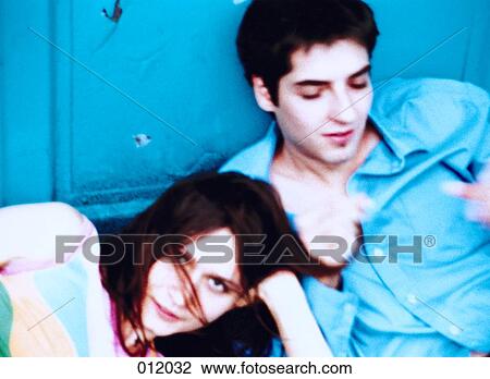 couple relxing against a wall outside View Large Photo Image Stock Image - couple relxing against a wall outside. Fotosearch