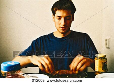 Stock Image - man eating breakfast. Fotosearch