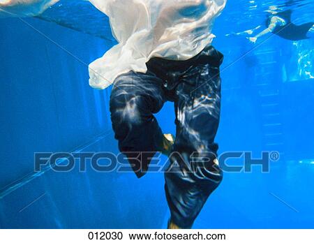 man swimming clother underwater View Large Photo Image Stock Image - man swimming clother underwater. Fotosearch