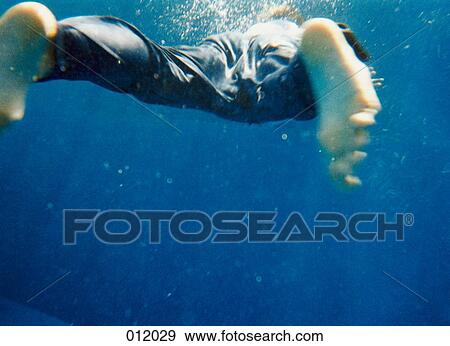 man swimming underwater View Large Photo Image Stock Photo - man swimming underwater. Fotosearch