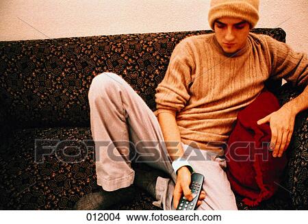 Picture - man using remote control. Fotosearch