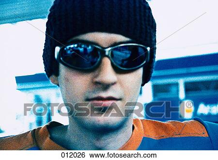 man wearing sunglasses looking directly at camera View Large Photo Image Stock Photograph - man wearing sunglasses looking directly at camera. Fotosearch
