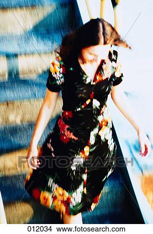 Picture - woman walking down stairs. Fotosearch