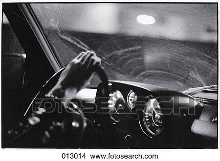 man holds steering wheel at night View Large Photo Image Picture - man holds steering wheel at night. Fotosearch