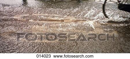 a bicycle riding through a flooded street View Large Photo Image Stock Image - a bicycle riding through a flooded street. Fotosearch