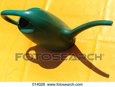 green watering can with shadow on a yellow table View Large Photo Image Stock Photo - green watering can with shadow on a yellow table. Fotosearch