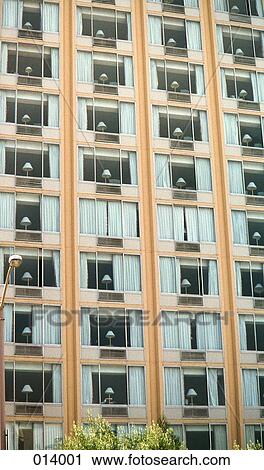 Stock Image - hotel building with lamps in all the windows. Fotosearch