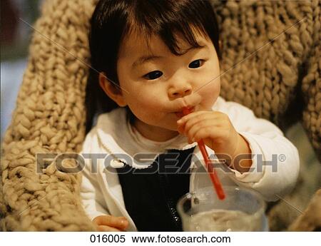 baby drinking out of red straw, sitting on parent's lap View Large Photo Image Stock Photography - baby drinking out of red straw, sitting on parent's lap. Fotosearch