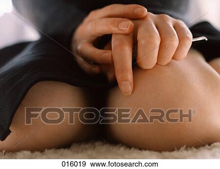 knees of a woman sitting down with her hands in her lap View Large Photo Image Stock Photo - knees of a woman sitting down with her hands in her lap. Fotosearch