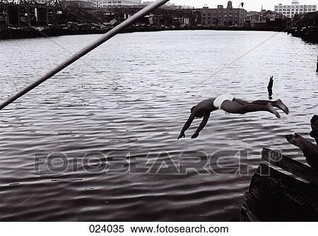 Man diving into a lake View Large Photo Image Stock Photography - Man diving into a lake. Fotosearch