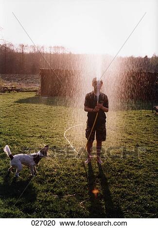 A boy spraying a garden hose View Large Photo Image Stock Image - A boy spraying a garden hose. Fotosearch