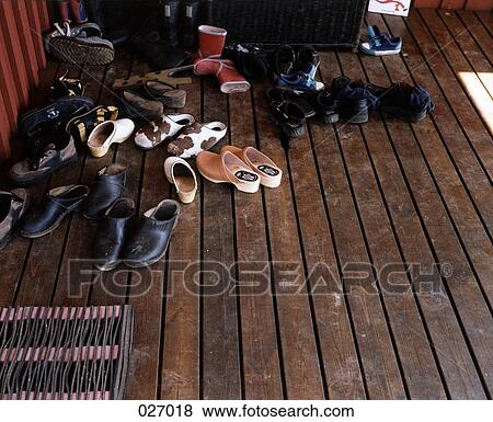 A collection of shoes on a porch View Large Photo Image Stock Photo - A collection of shoes on a porch. Fotosearch