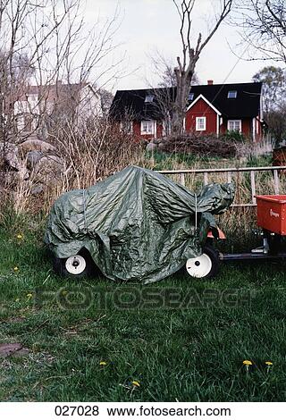 A covered trailer parked in the grass View Large Photo Image Stock Photo - A covered trailer parked in the grass. Fotosearch