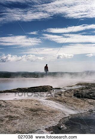 Person standing on a volcanic landscape View Large Photo Image Stock Photo - Person standing on a volcanic landscape. Fotosearch