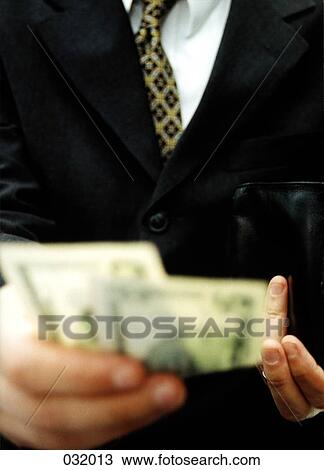 A businessman paying cash View Large Photo Image Stock Image - A businessman paying cash. Fotosearch
