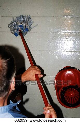 A man cleaning a floor View Large Photo Image Stock Photo - A man cleaning a floor. Fotosearch