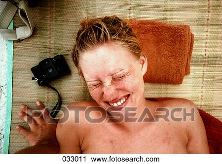 A smiling woman sunbathing View Large Photo Image Stock Image - A smiling woman sunbathing. Fotosearch