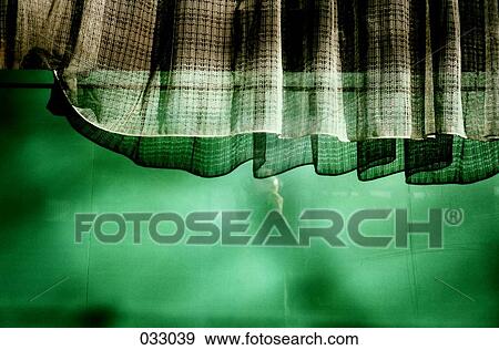 Curtains hanging down over a green-lit wall View Large Photo Image Stock Photo - Curtains hanging down over a green-lit wall. Fotosearch