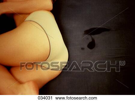 A woman lying in her underwear View Large Photo Image Stock Image - A woman lying in her underwear. Fotosearch
