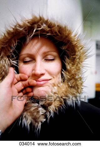 A woman with a hooded-jacket smiling with eyes closed View Large Photo Image Picture - A woman with a hooded-jacket smiling with eyes closed. Fotosearch