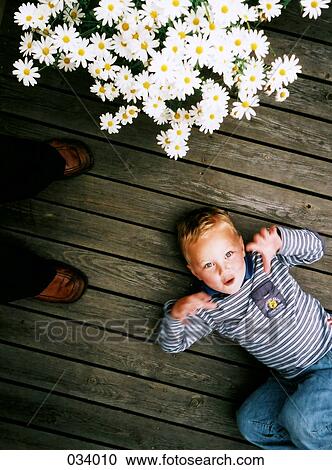 Aerial view of a child laying down View Large Photo Image Stock Image - Aerial view of a child laying down. Fotosearch