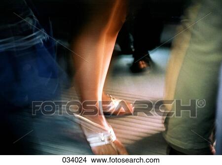 Picture - Blurred image of a woman's feet with sandals. Fotosearch